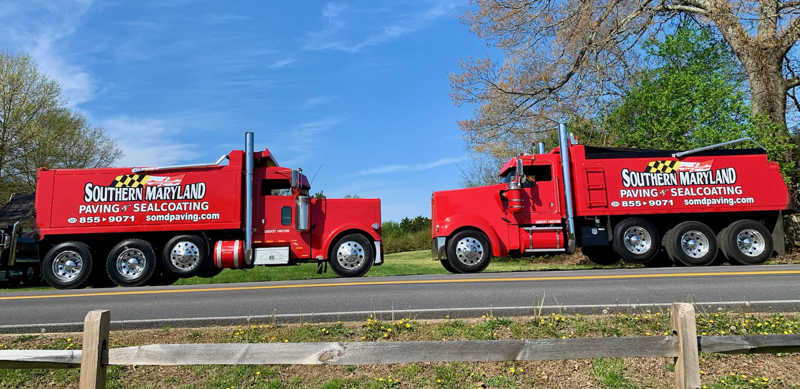 Two red dumptrucks facing each other